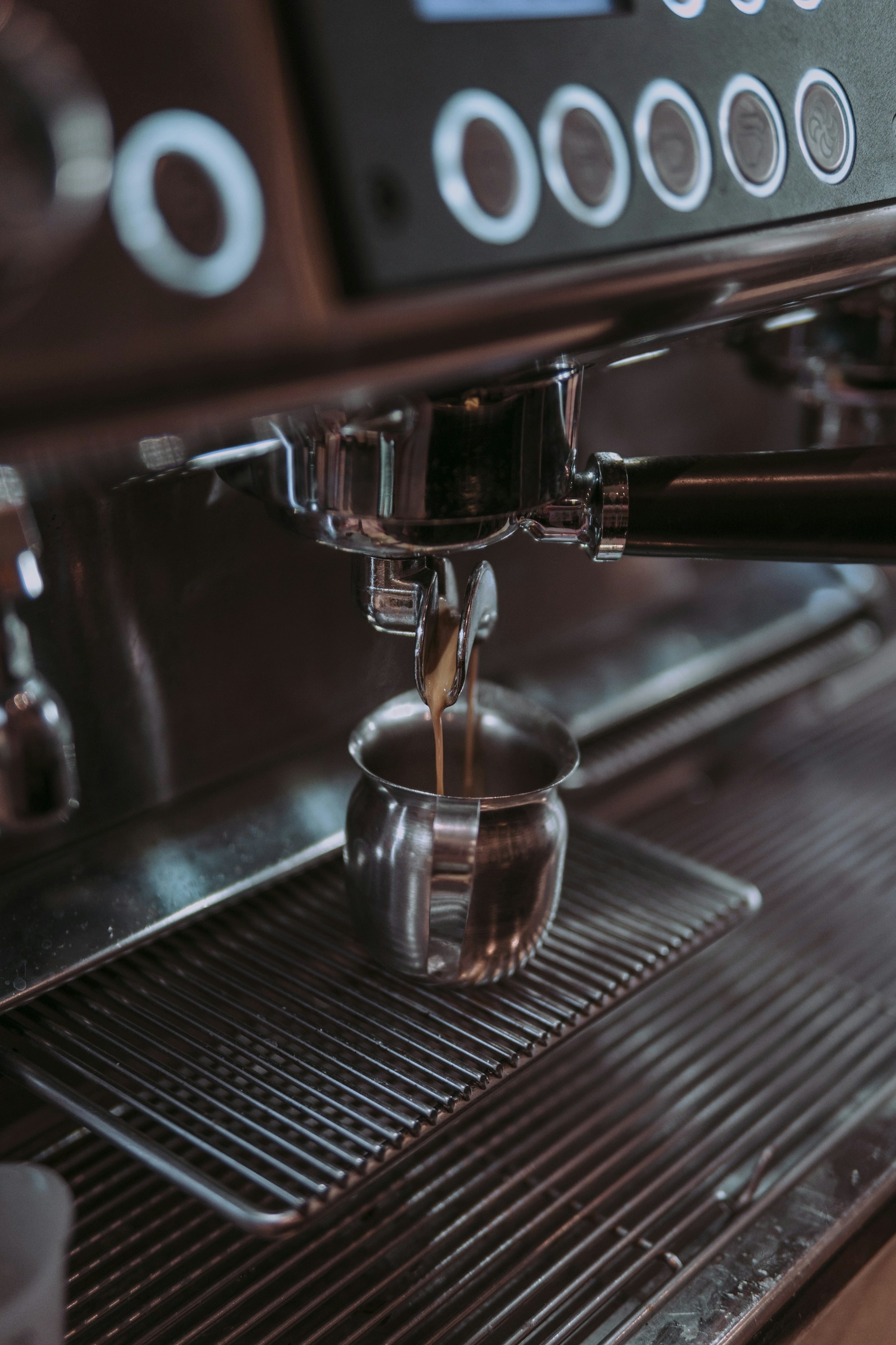 Fresh espresso extracting into a clear glass
